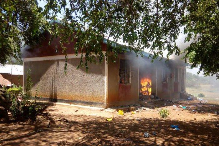 One of the houses on fire after angry residents stormed a police station after suspect’s controversial death in cell