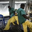 A team of medical workers are seen putting on their Personal Protective Equipment (PPE) ahead of entering an Ebola Treatment Centre run by The Alliance for International Medical Action (ALIMA) on August 11, 2018 in Beni, northeastern DRC