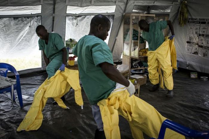 A team of medical workers are seen putting on their Personal Protective Equipment (PPE) ahead of entering an Ebola Treatment Centre run by The Alliance for International Medical Action (ALIMA) on August 11, 2018 in Beni, northeastern DRC