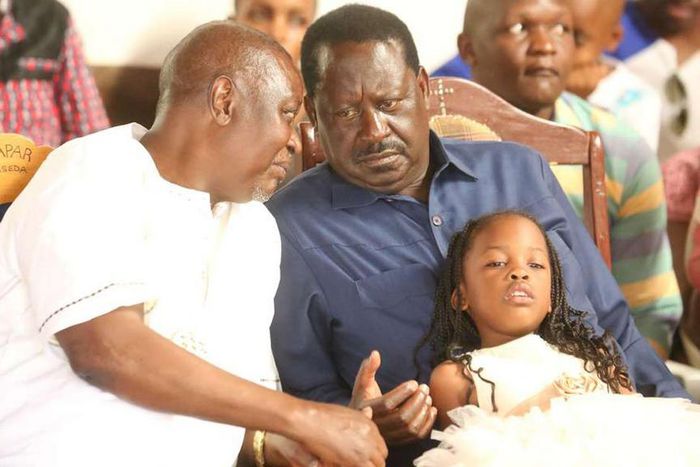 ODM party leader Raila Odinga speaks with hie elder brother Oburu Odinga at a past public event