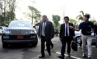 Premchai Karnasuta (left), who is charged with a slew of offences related to poaching, arrives at court to hear the verdict