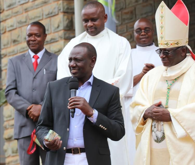 File image of DP Ruto pesenting a donation to Embu Catholic Bishop Paul Kariuki , on September 22