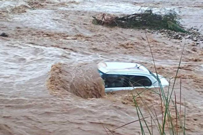 Vehicle swept away by floods