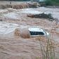 Vehicle swept away by floods