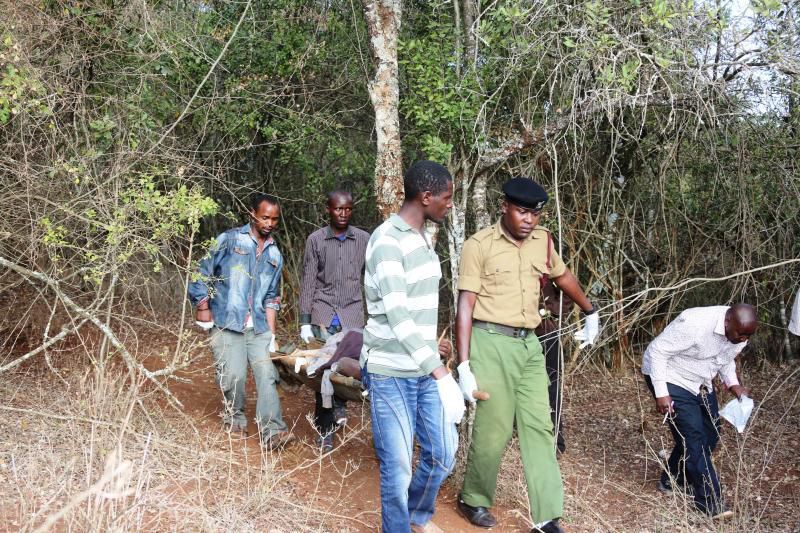 Officers carry away an unidentified body