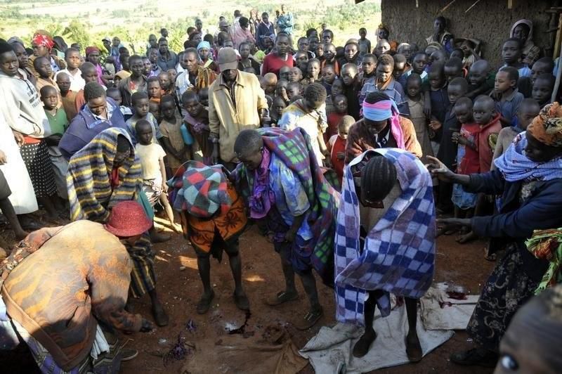 A fiile photo of people gathered around teenage girls who have just undergone female genital mutilation. REUTERS/James Akena