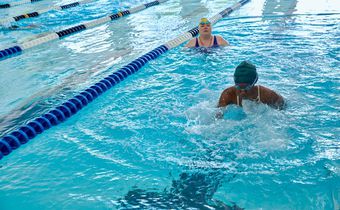 Durbin looks on as Washington swims breast stroke.