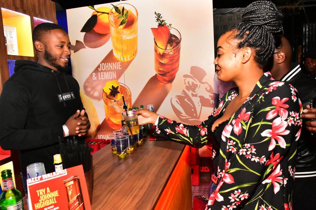 INSTAGRAMMER GEORGE KIMANI SERVES A JOHNNIE WALKER HIGHBALL TO A CONSUMER