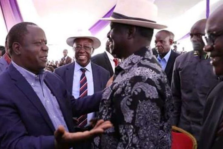 Raila Odinga with Fred Matiangi at the burial of Hezron Manduku