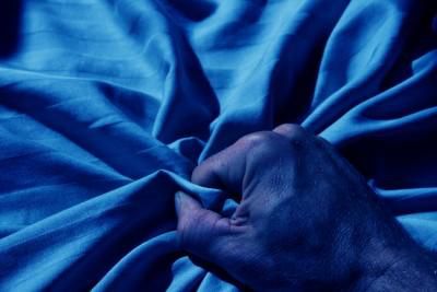 Hand grabbing sheets during sex (Courtesy)