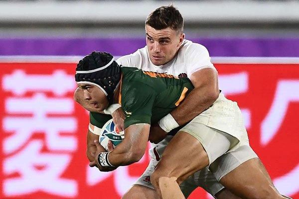 England's George Ford tackles South Africa's Cheslin Kolbe (left)
