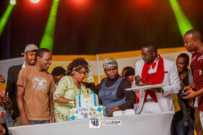 Teacher Wanjiku (cutting cake) and other comedians with Churchill (in white) celebrate Churchill at 40 (Twitter)