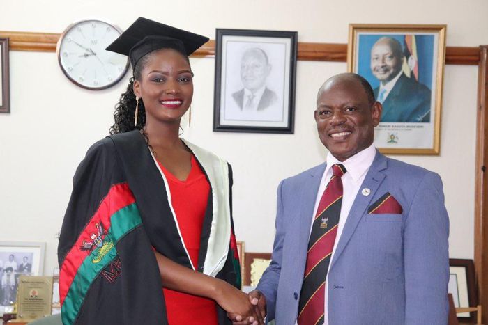 Miss Uganda Queen Abenakyo shaking hands with Makerere Universit Vice Chancellor Nawawgwe