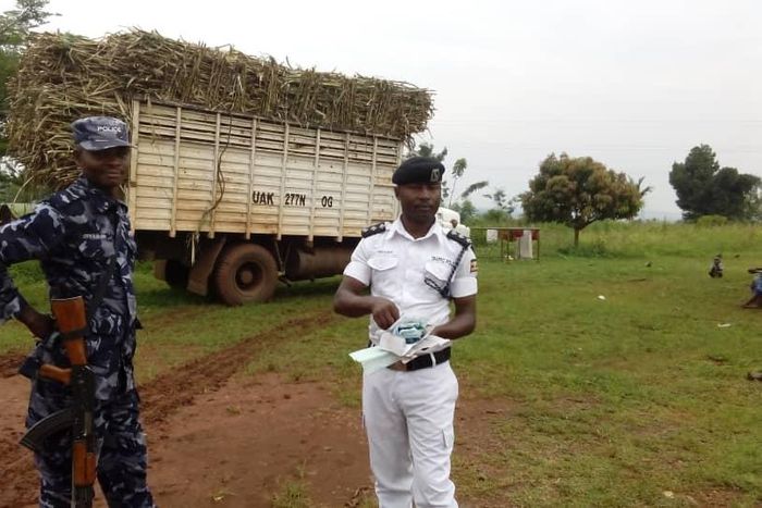 Police officer standing next to a sugarcane truck which rammed into a crowd in Njeru