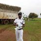 Police officer standing next to a sugarcane truck which rammed into a crowd in Njeru