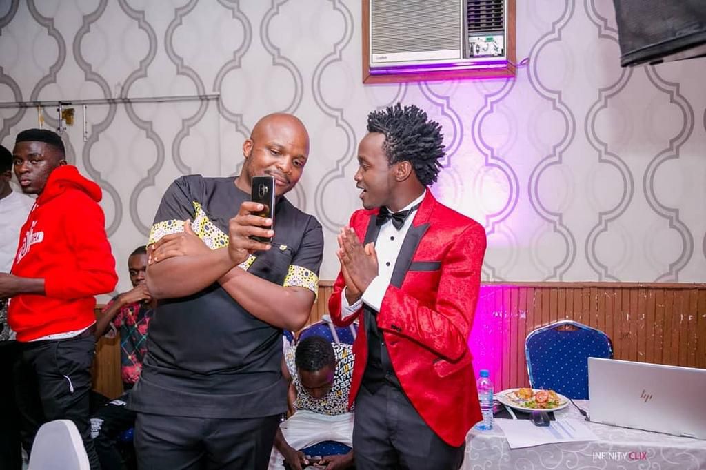 Celebrities at the EMB Rebirth Party . Bahati signs Dany Gift