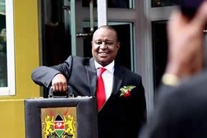 Finance Cabinet Secretary Henry Rotich poses with the traditional budget briefcase outside Parliament