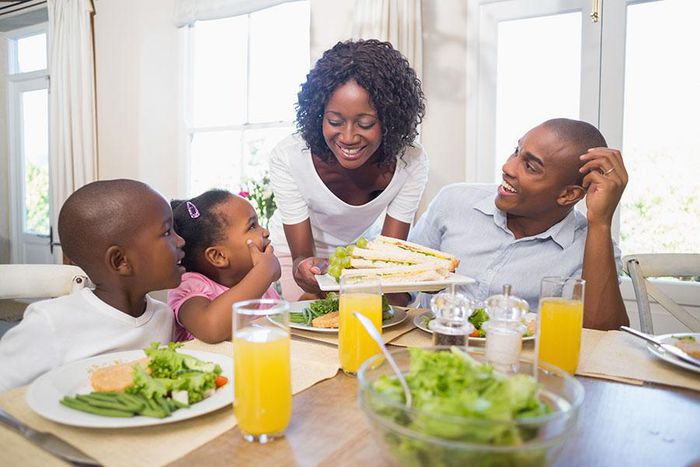 Happy family enjoying meal(orthobridgeorthopedics)