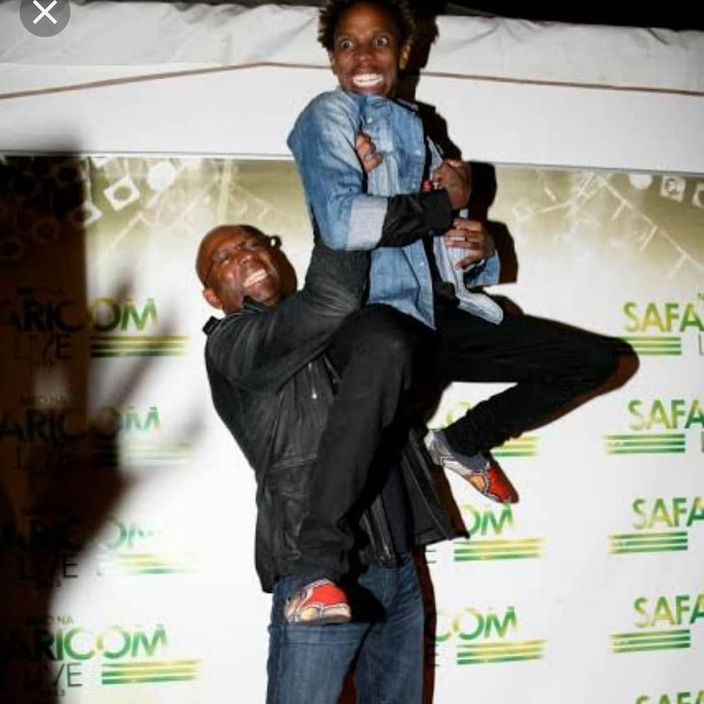 Eric Omondi with the late  Safaricom CEO Bob Collymore