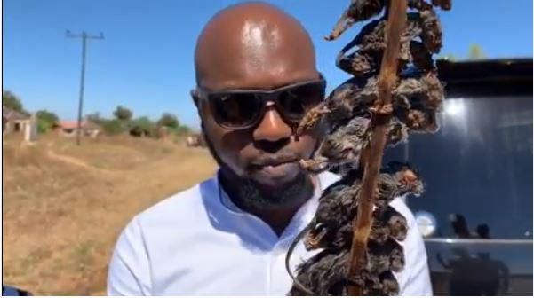 Larry Madowo eating Mouse