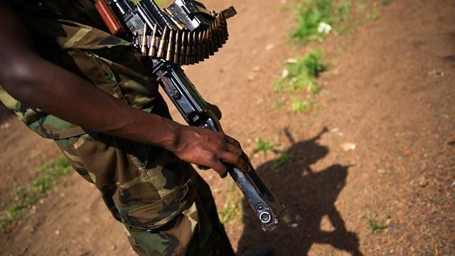 A soldier holding his firearm