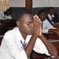 A student praying in an examination room