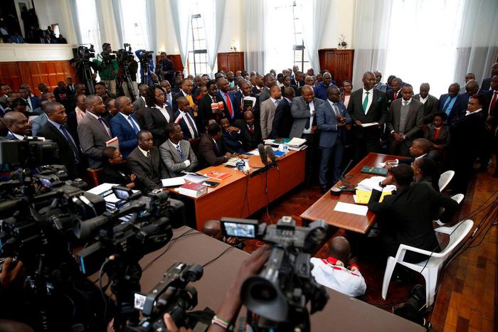 Lawyers and journalists attend a court hearing