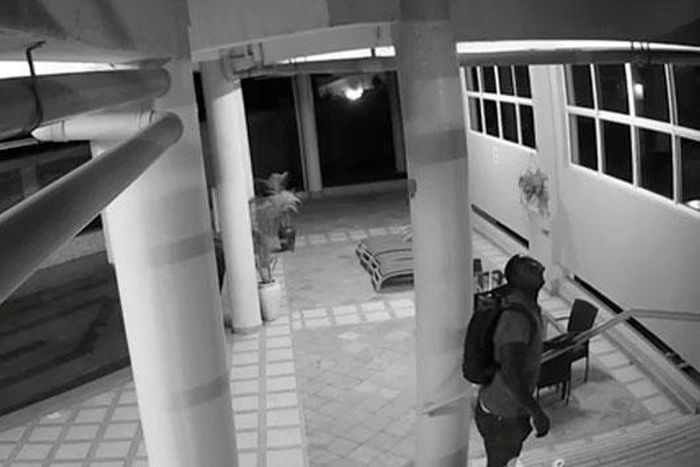 'Spiderman' is seen here before scaling a wall at an apartment block