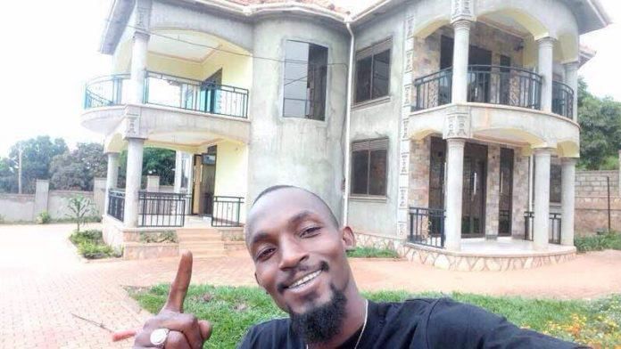 Mowzey Radio posing next to his house in Entebbe