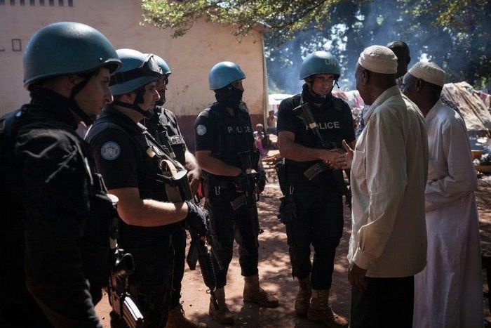 Jordanians peacekeepers meet Muslim refugees at an internally displaced persons camp in Bangassou on October 25, 2017