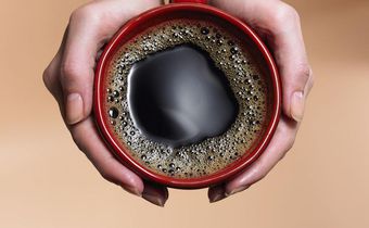 &quot;Woman holding coffee cup, close-up, overhead view&quot;