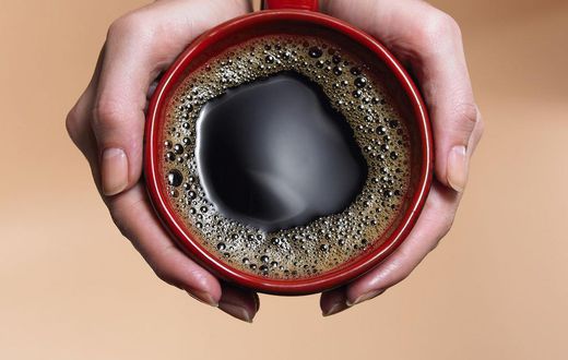 &quot;Woman holding coffee cup, close-up, overhead view&quot;