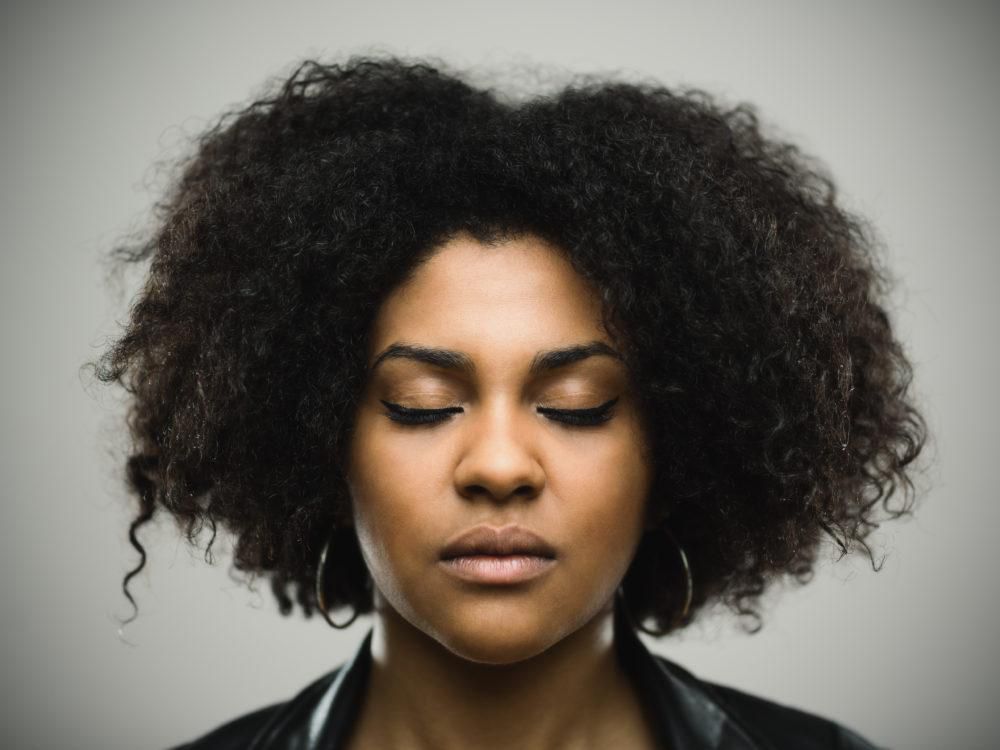 Black woman closing eyes(Black Enterprise)