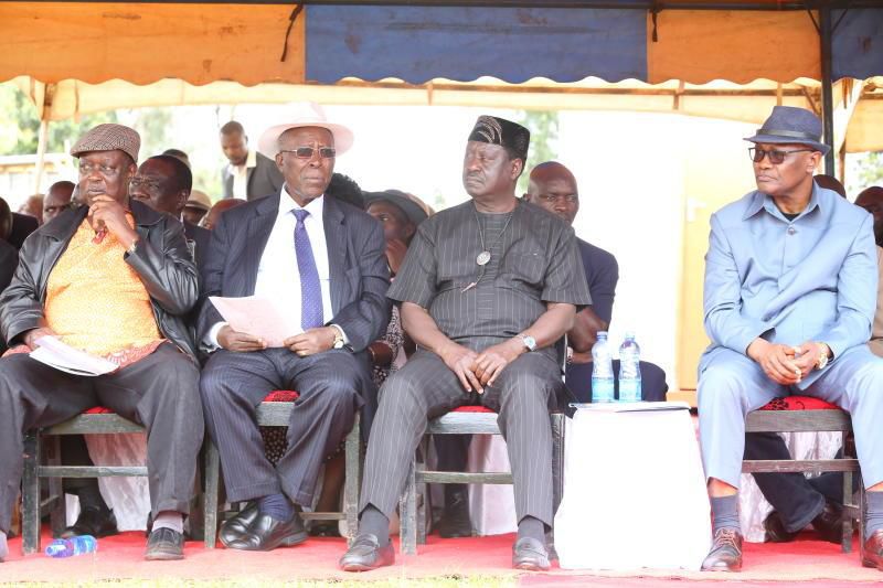 Raila Odinga flanked by other leaders during the burial of Dr David Ombati in Kisii yesterday