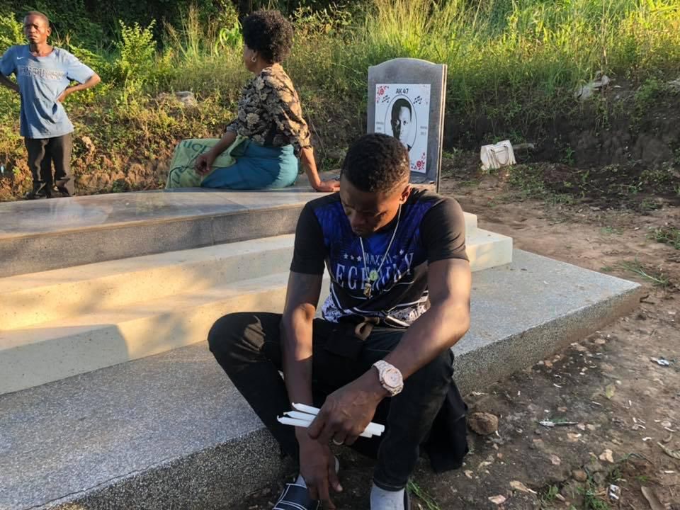 Chameleone and hist Mother sitting  by AK47's grave