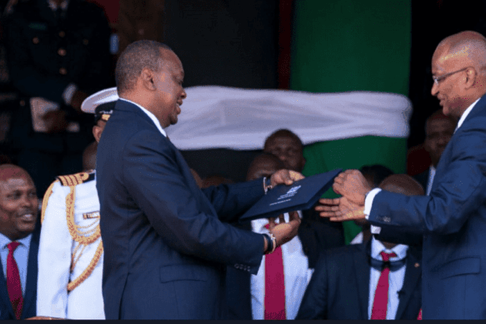 CBK Governor Patrick Njoroge presents the new generation notes to President Uhuru Kenyatta on 01 June 2019  during the Madaraka Day celebrations in Narok