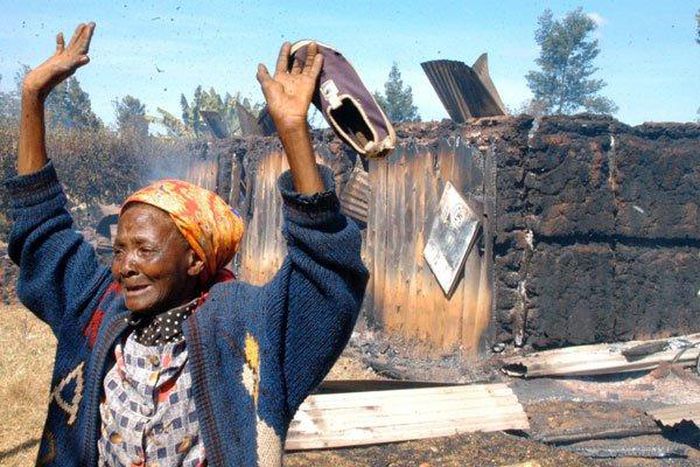 The widely shared photo of Elizabeth Wangui standing at the scene where 50 people were burnt to death at Kiambaa KAG Church