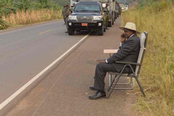Ugandan president, Yoweri Museveni, making a phone call on the road side