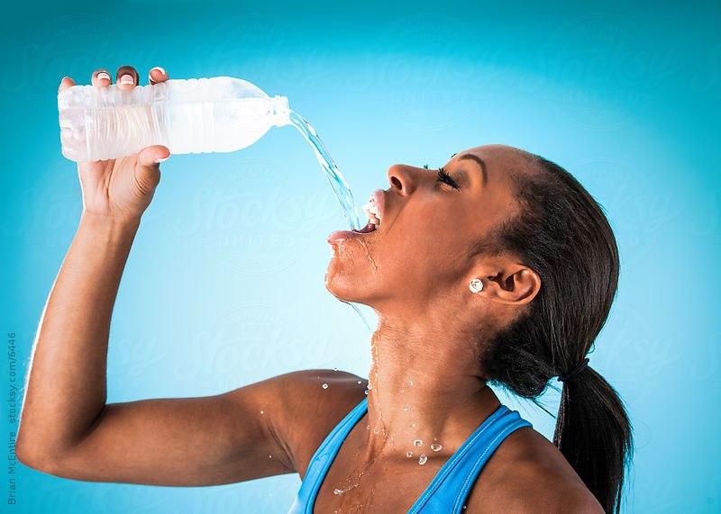 Sports woman drinking water