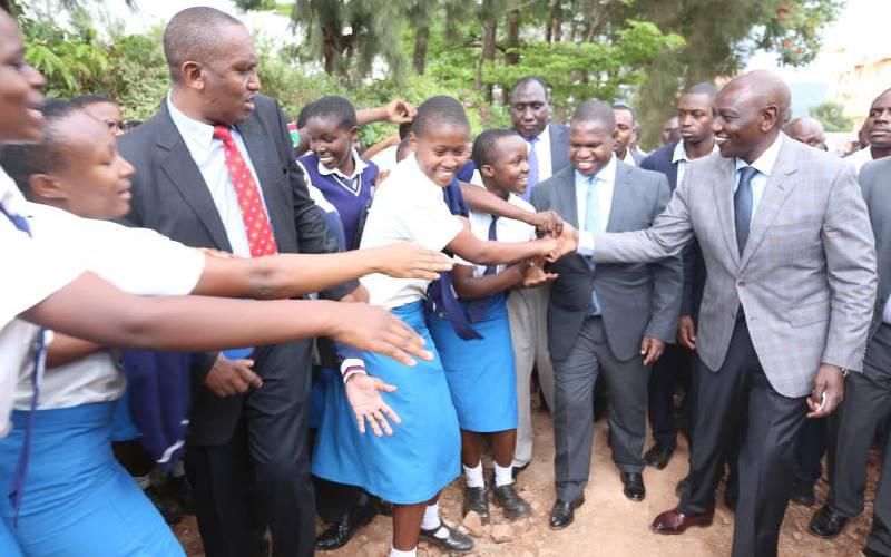 Deputy President William Ruto interacts with Nyanchwa Sevent Day Adventist Girls Secondary school students on 30 March 2019 when the controversial harambee was held