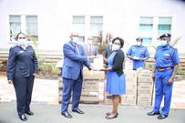 Ms Roselyn Linguli, representative of U.S. Embassy INL office, presents PPE to National Police Service, represented by Inspector General Hillary Mutyambai