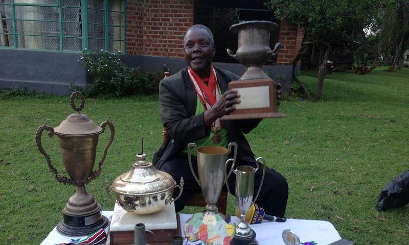 Athletics legend Benjamin Jipcho Chemaima showcasing some of his awards during a past media interview