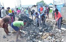 A group of Kenyan youth engaged in a clean-up exercise under the Youth Mtaani initiative