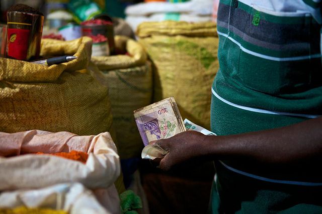 A trader attends to a customer (Photo: Abraham Ali)