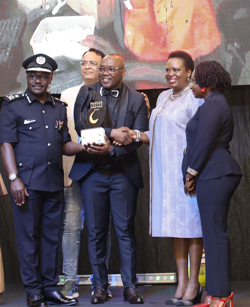 Kennedy Omondi, Principal Indomie Uganda recieveing the award from the Minister Hon. Betty Amongi, Minister of Gender, Labour, and Social Development