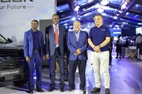 Moses Kaggwa, the Acting Director of the Ministry of Finance (2nd R) poses with Jetour officials at the launch