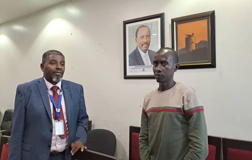 URA's Robert Kalumba parading the suspect Ivan Cyubahiro before pressmen
