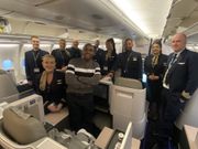 Dr. Jonathan Ssozi  Mulungi posing with the flight crew on a Brussels Airlines flight