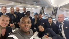 Dr. Jonathan Ssozi  Mulungi posing with the flight crew on a Brussels Airlines flight