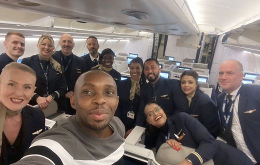 Dr. Jonathan Ssozi  Mulungi posing with the flight crew on a Brussels Airlines flight